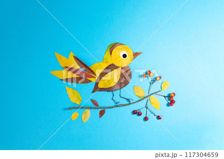 bird made out of leaf on blue background, autumn craft for kid, animal clipart collage made of dry dead leaves, fall DIY, 117304659