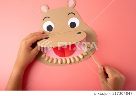 Handcrafted paper hippo with toothbrush puppet, designed for kids, crafted from cardboard 117304847