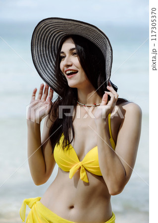 Woman on beach and sand during summer vacation. Woman on beach and sand during summer vacation. 117305370