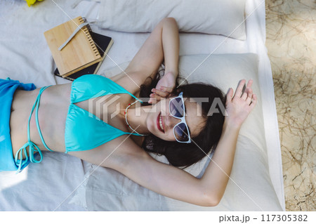 Woman on beach and sand during summer vacation. Woman on beach and sand during summer vacation. 117305382