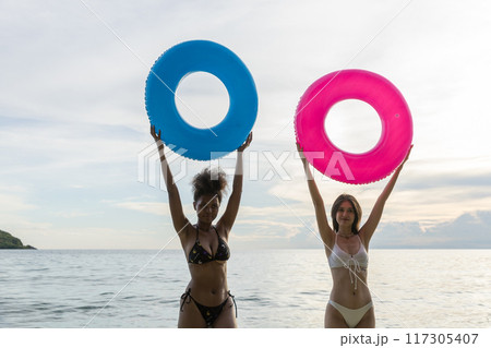 Woman on beach and sand during summer vacation Woman on beach and sand during summer vacation 117305407