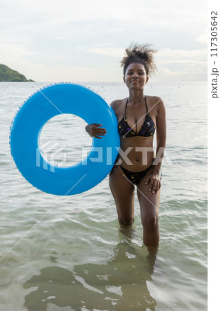 Beautiful girl on sun tanning in a tropical beach 117305642