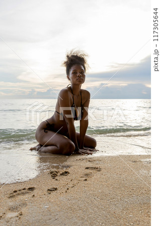Beautiful girl on sun tanning in a tropical beach Beautiful girl on sun tanning in a tropical beach 117305644