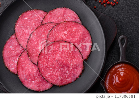 Delicious smoked salami sausage sliced with salt, spices and herbs Delicious smoked salami sausage sliced with salt, spices and herbs 117306581