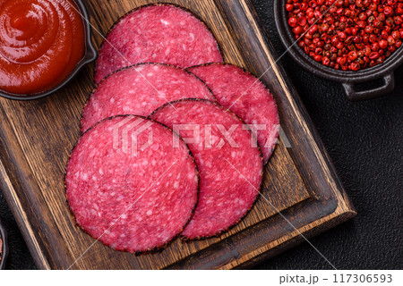 Delicious smoked salami sausage sliced with salt, spices and herbs 117306593