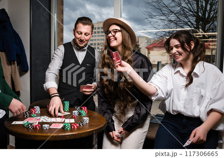 A team of young boys and girls play poker. First-person observation of card poker from various close-up angles. A team of young boys and girls play poker. First-person observation of card poker from various close-up angles. 117306665