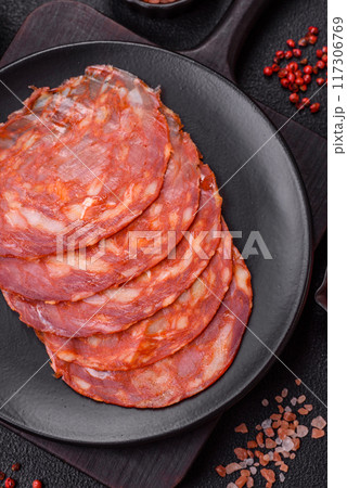 Delicious smoked meat sliced with salt, spices and herbs Delicious smoked meat sliced with salt, spices and herbs 117306769