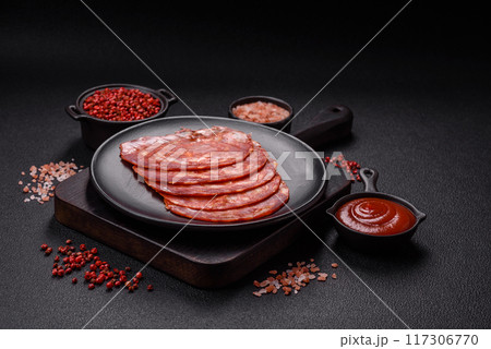 Delicious smoked meat sliced with salt, spices and herbs 117306770
