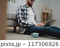 Businessman working at home on paperwork.  117306826