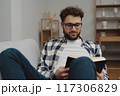 Businessman working at home on paperwork.  117306829