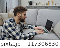 Businessman working at home on paperwork.  117306830