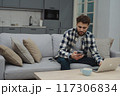Businessman working at home on paperwork.  117306834