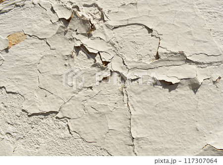 white peeling paint wall background, texture of a concrete old wall with stains and cracks 117307064