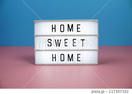 Home Sweet Home letterboard text on LED Lightbox on pink and blue background 117307102