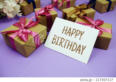 Happy Birthday card with gift box presents on purple background Happy Birthday card with gift box presents on purple background 117307117