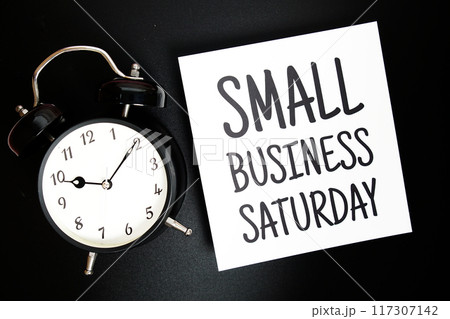 Small Business Saturday text with alarm clock on black background Small Business Saturday text with alarm clock on black background 117307142