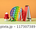 Group of colored stationery. rocket pencils on yellow background with rocket. Brain teaser and development for back to school or education. Bright accessories. Success achievement ideas 117307389