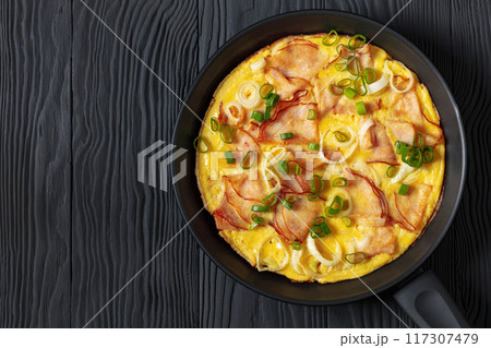 deli ham onion omelette on skillet, top view deli ham onion omelette on skillet, top view 117307479