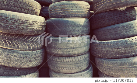 Pile of old used car tires outdoors 117307815