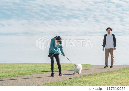 青空の見える公園で犬の散歩・運動・トレーニング・有酸素運動をするさわやかな家族・親子 青空の見える公園で犬の散歩・運動・トレーニング・有酸素運動をするさわやかな家族・親子 117310953