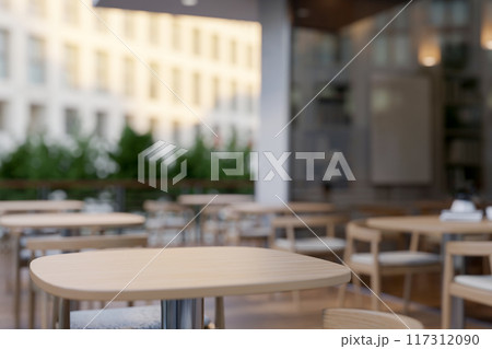 A space for displaying products on a wooden table on a restaurant or coffee shop outdoor terrace. 117312090
