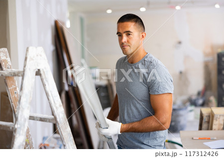 Repairman working in construction site in apartment Repairman working in construction site in apartment 117312426