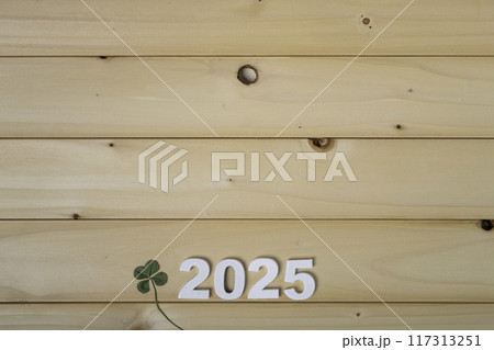 2025年　木材の背景と四つ葉のクローバーの年賀状素材 117313251