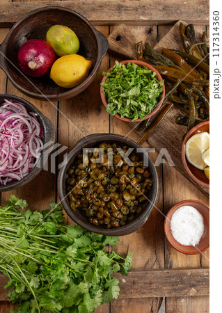 Ingredientes for seaweed cochayuyo seviche cebiche Chilean Australin peruvian cochayuyo, red onion, cilantro and lemon 117314360