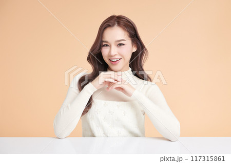 Beautiful young asian woman with clean fresh skin on beige background, Face care, Facial treatment, Cosmetology, beauty and spa, Asian women portrait. 117315861