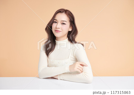 Beautiful young asian woman with clean fresh skin on beige background, Face care, Facial treatment, Cosmetology, beauty and spa, Asian women portrait. Beautiful young asian woman with clean fresh skin on beige background, Face care, Facial treatment, Cosmetology, beauty and spa, Asian women portrait. 117315863