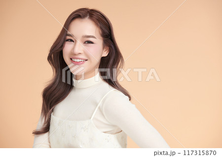 Beautiful young asian woman with clean fresh skin on beige background, Face care, Facial treatment, Cosmetology, beauty and spa, Asian women portrait. 117315870