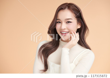 Beautiful young asian woman with clean fresh skin on beige background, Face care, Facial treatment, Cosmetology, beauty and spa, Asian women portrait. Beautiful young asian woman with clean fresh skin on beige background, Face care, Facial treatment, Cosmetology, beauty and spa, Asian women portrait. 117315872