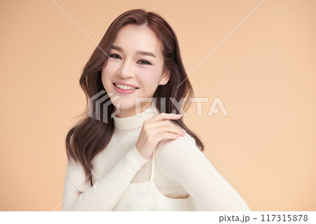 Beautiful young asian woman with clean fresh skin on beige background, Face care, Facial treatment, Cosmetology, beauty and spa, Asian women portrait. 117315878
