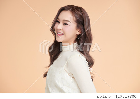Beautiful young asian woman with clean fresh skin on beige background, Face care, Facial treatment, Cosmetology, beauty and spa, Asian women portrait. 117315880