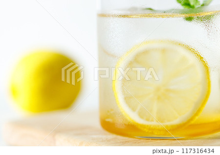 Lemonade with lemon and mint in a glass. Lemonade with lemon and mint in a glass. 117316434