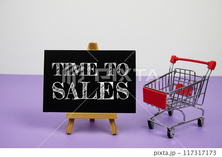 Time to Sales text message and trolley shopping cart on purple background Time to Sales text message and trolley shopping cart on purple background 117317173