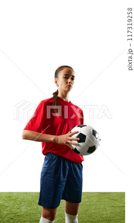 Confident young woman, football athlete posing in uniform and holding ball against white background. Confident young woman, football athlete posing in uniform and holding ball against white background. 117319258