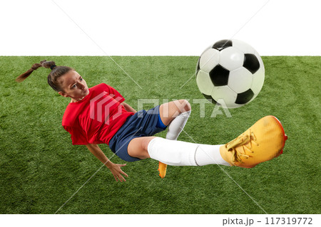 Female soccer player mid-air, executing bicycle kick with precision and power, showcasing athleticism and skill. 117319772
