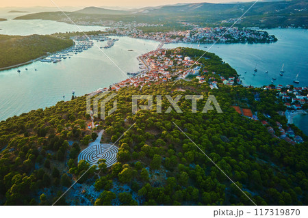 Panoramic view of islands in Adriatic Sea and hedge maze among forest trees at sunset. Lavender labyrinth in Rogoznica, Croatia. Aerial view of coastal landscape. Place for summer vacation Panoramic view of islands in Adriatic Sea and hedge maze among forest trees at sunset. Lavender labyrinth in Rogoznica, Croatia. Aerial view of coastal landscape. Place for summer vacation 117319870