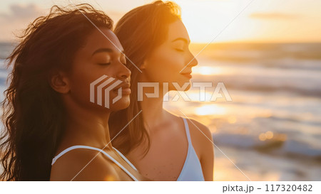 Celebrating the beauty of friendship at sunset on the beach together 117320482