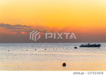Beautiful yellow and orange sunrise over the sea. 117321816