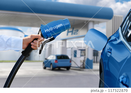 Man holds a hydrogen fueling nozzle. Refueling car with hydrogen fuel 117322870