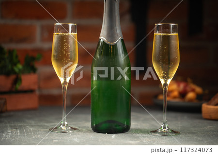 Bottle of champagne and two glasses Bottle of champagne and two glasses 117324073