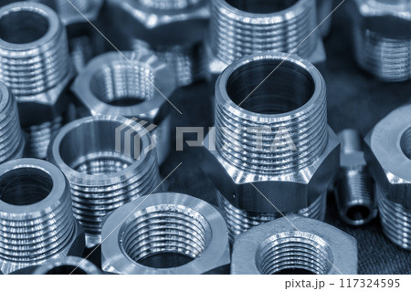 The pile of steel water pipe connector parts in the light blue scene. The pile of steel water pipe connector parts in the light blue scene. 117324595