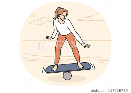 Toned woman balancing on board on beach 117326789