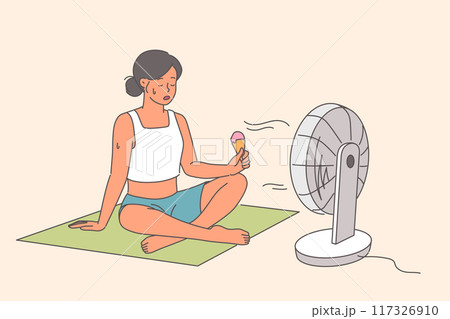 Electric fan blows on woman eating ice cream, sitting on floor in hot weather during summer season Electric fan blows on woman eating ice cream, sitting on floor in hot weather during summer season 117326910