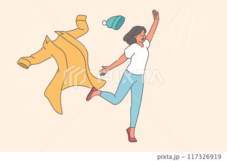 Woman takes off winter clothes and runs towards sun rays, rejoicing at onset of summer or warming Woman takes off winter clothes and runs towards sun rays, rejoicing at onset of summer or warming 117326919