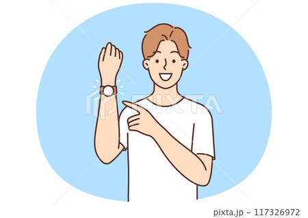Smiling man point at wristwatch 117326972