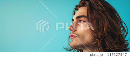Young Man with Long Hair Gazing Upwards 117327347