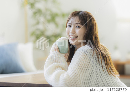 部屋でくつろぐニットの若い女性 部屋でくつろぐニットの若い女性 117328779